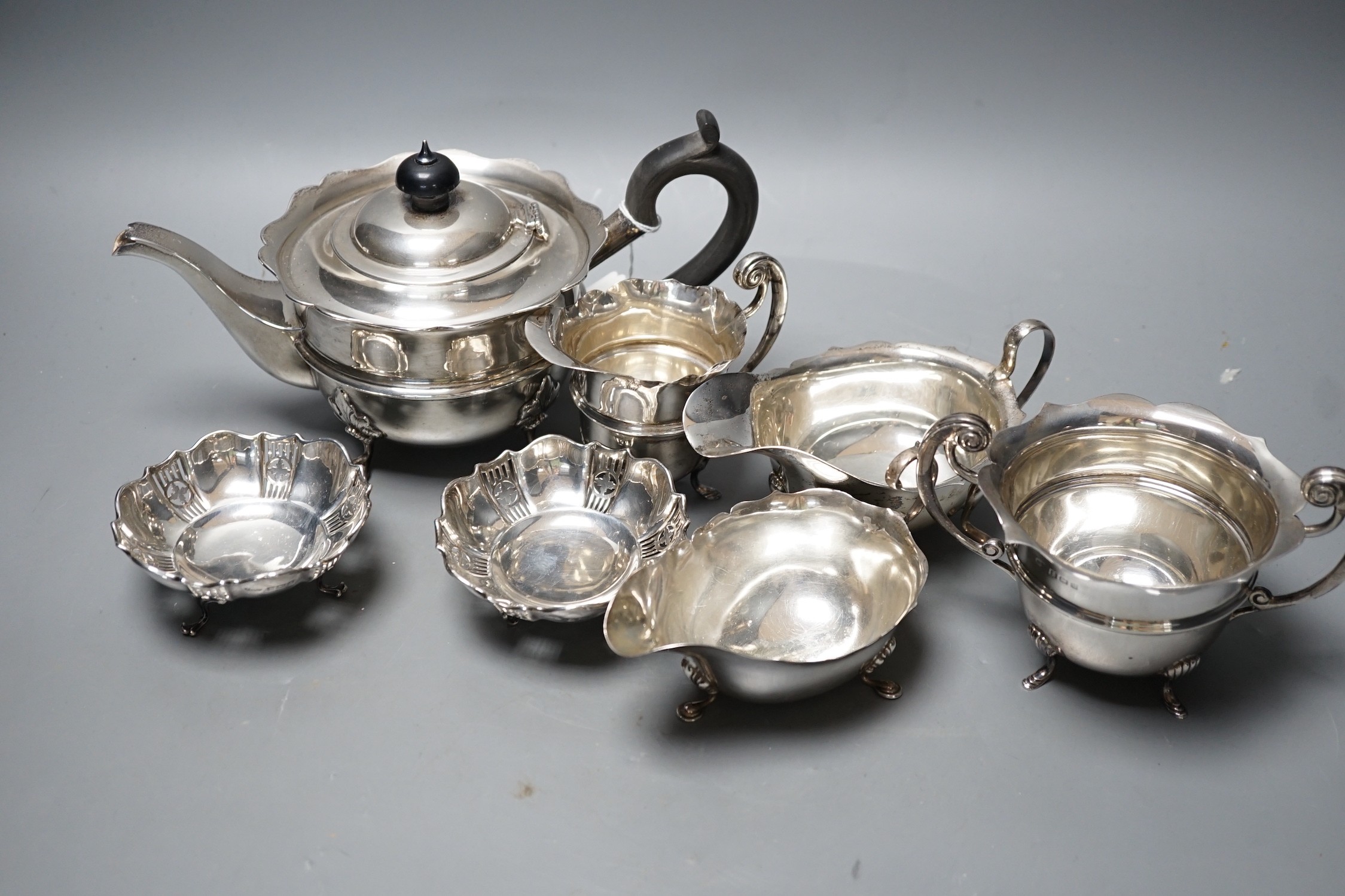 Small silver including tea pot, cream and sugar, two sauceboats and a pair of small dishes, 29.9oz.